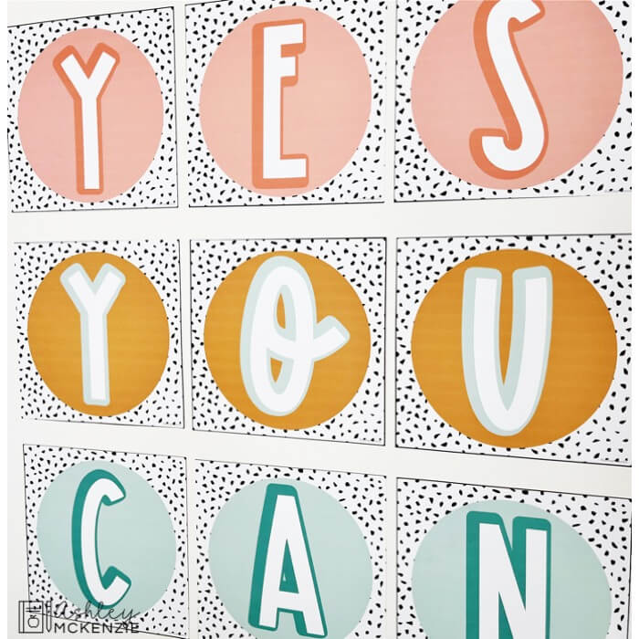 Decorative word posters featuring a terrazzo design and the words "Yes You Can." These posters create a wall display with pink, yellow, and teal hues.