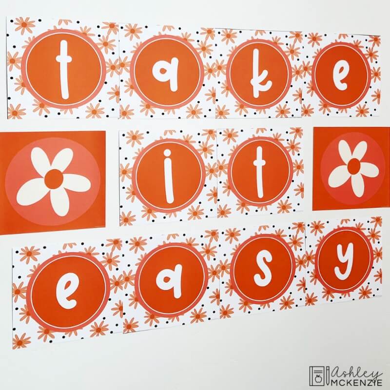 A large wall display in a classroom featuring the saying "Take it easy" in a fun daisy theme.