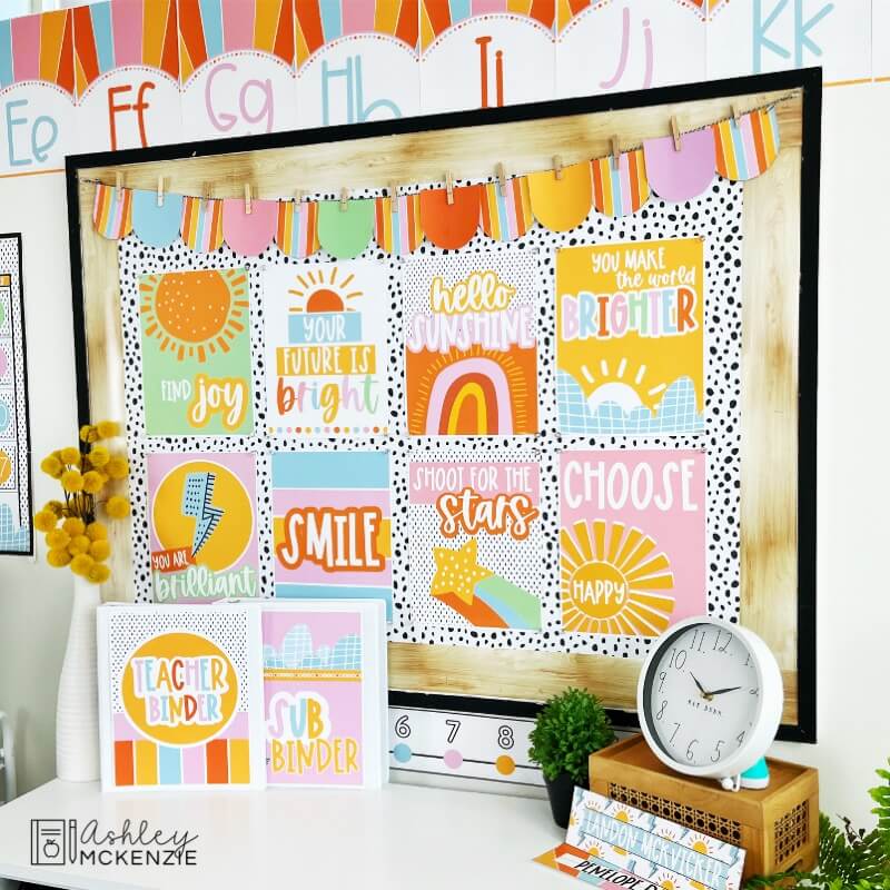 A classroom bulletin board features brightly colored sunshine classroom posters with a variety of positive sayings.