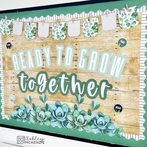 A classroom bulletin board decorated with a modern greenery theme and the saying "Ready to Grow Together"