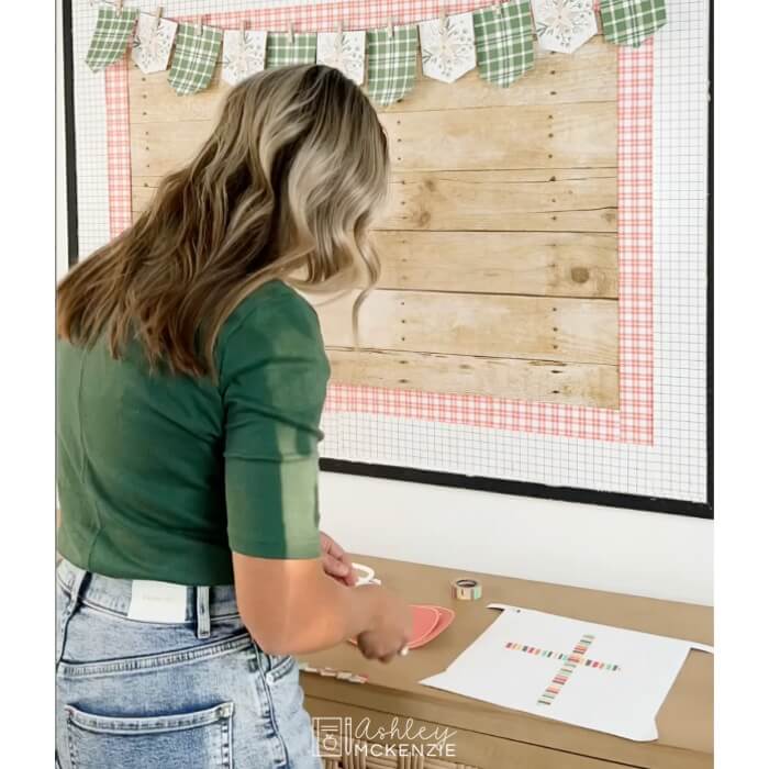 How to decorate your bulletin board using washi tape to place items and decide where you want them before securing them with staples.
