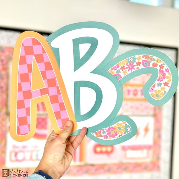Bulletin Board Letters A, B, and C in uppercase are held up; they feature bright Valentine's Day themed designs.