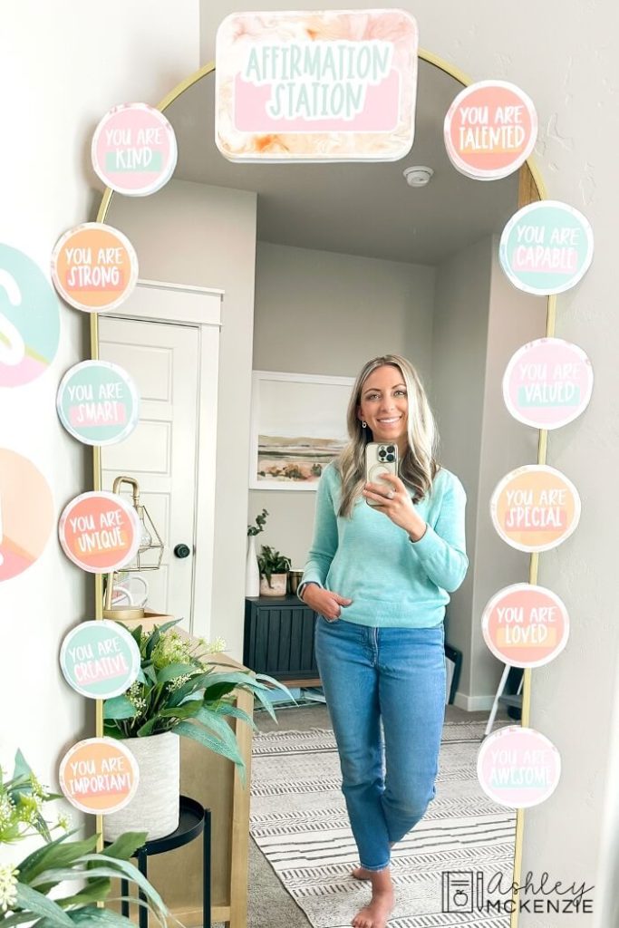 A mirror decorated with affirmations like "You are kind" and "You are talented" in a pastel theme