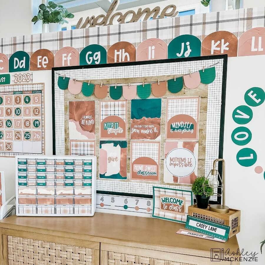 A classroom bulletin board features posters with a plaid design and a calming color palette