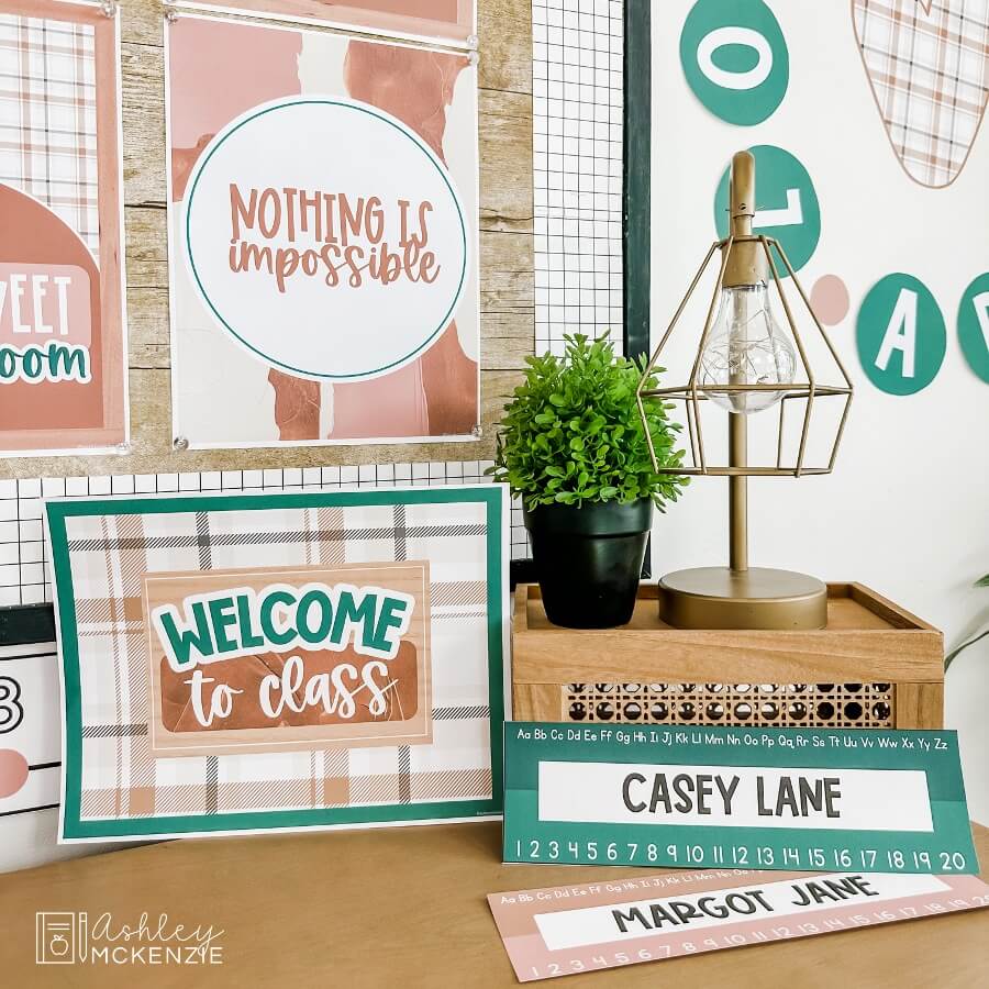 A "welcome to class" sign with a plaid background, and two desk name tags for students