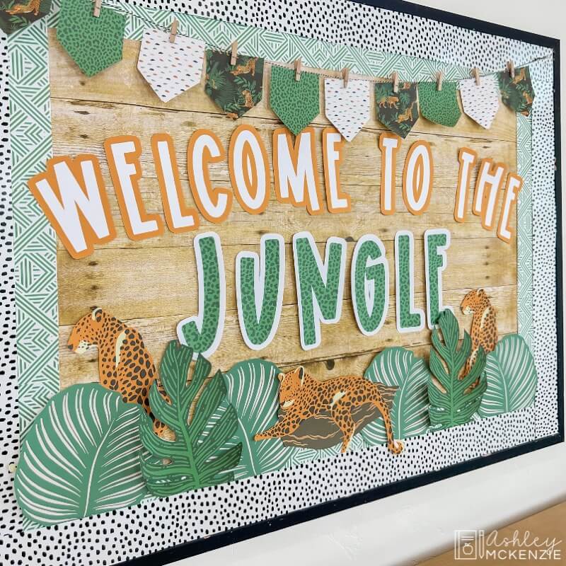 A classroom bulletin board decorated with a modern jungle theme featuring the saying "Welcome to the Jungle"