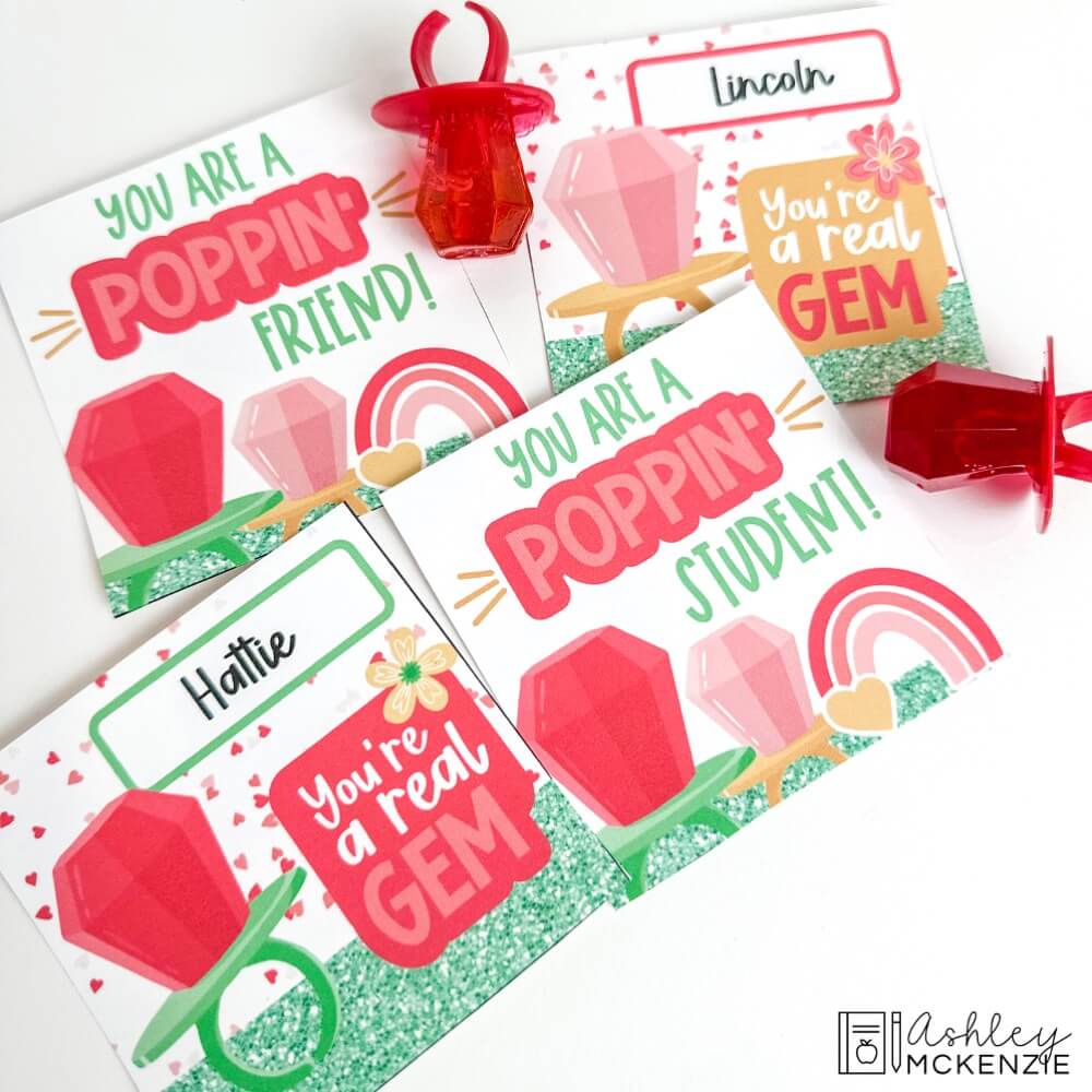 Multiple Valentine cards are shown with a couple of red ring pops